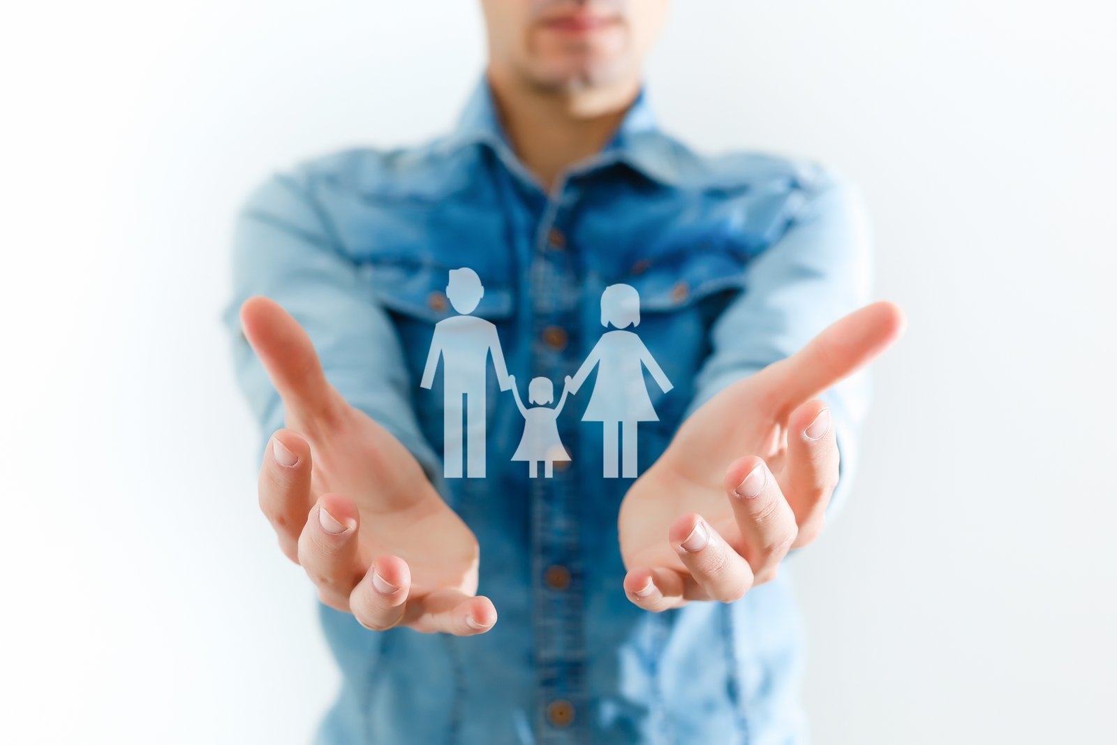 A Life Insurance Policy document on a desk next to a financial security lockbox, with floating family and insurance icons